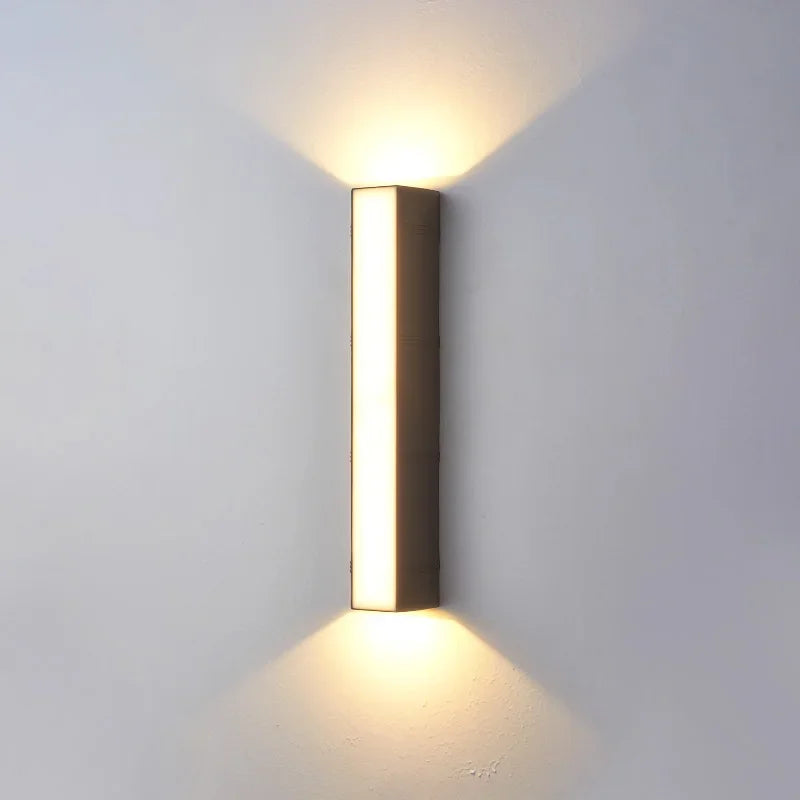 Modern Outdoor LED Strip Wall Lamp in warm white beside a bed