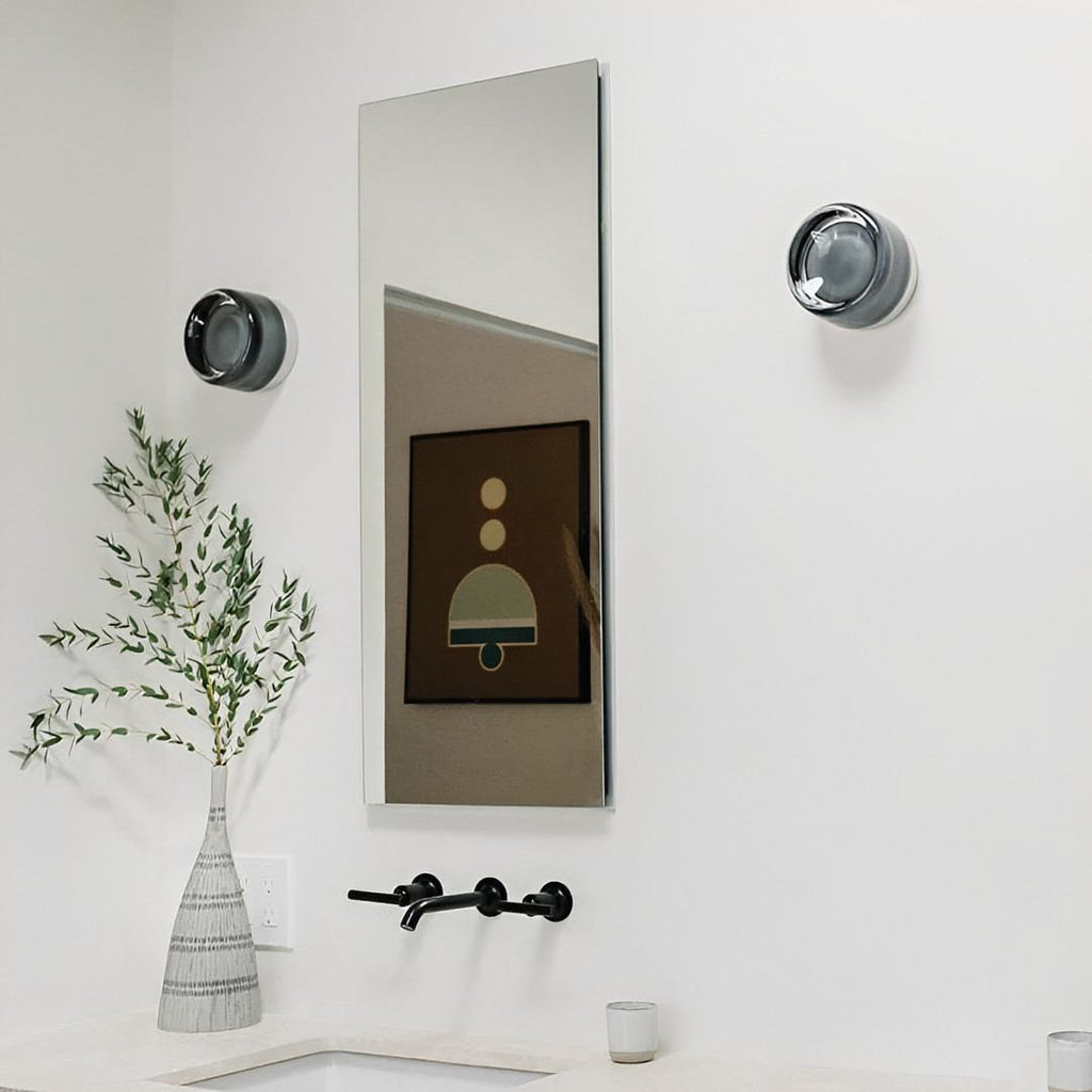 Compact Wall Light - DimpleGlow in white beside a bed