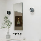 Compact Wall Light - DimpleGlow in white beside a bed