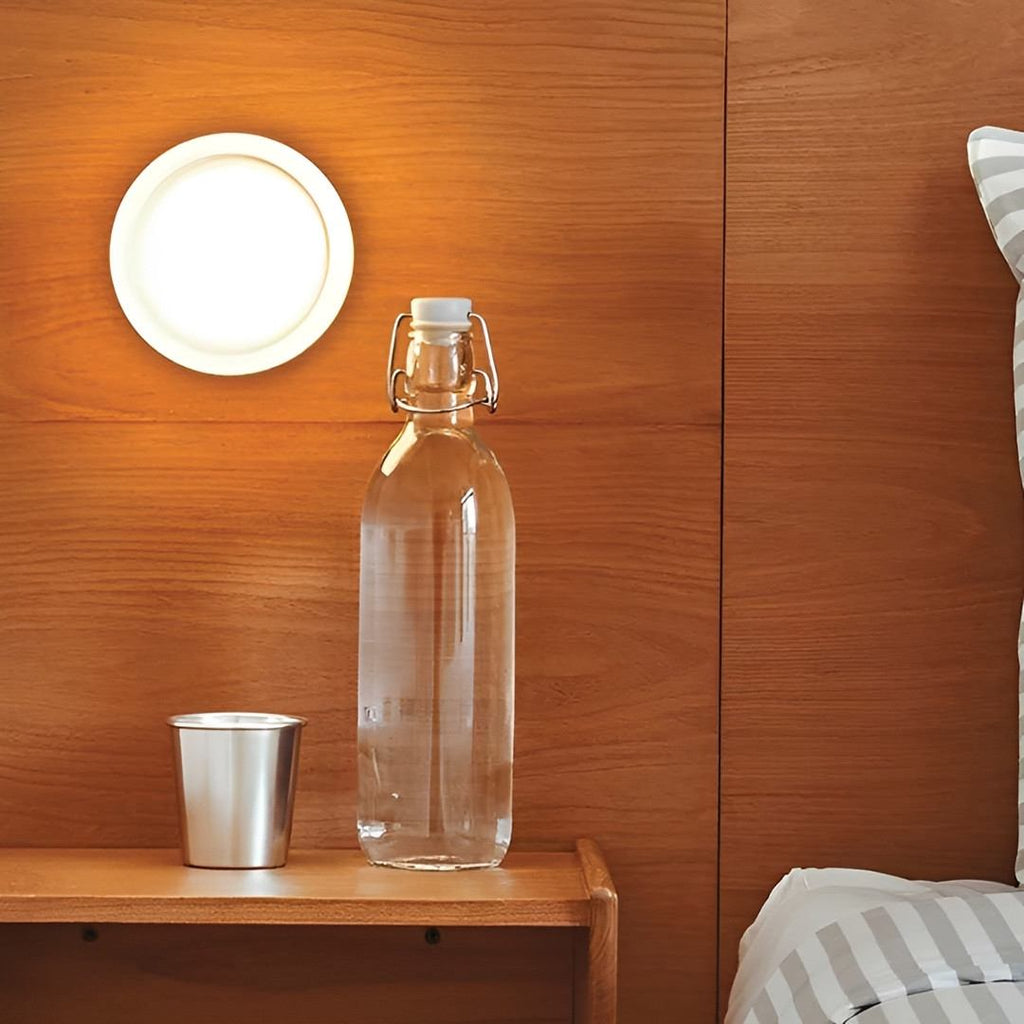 Compact Wall Light - DimpleGlow in amber in a stairwell