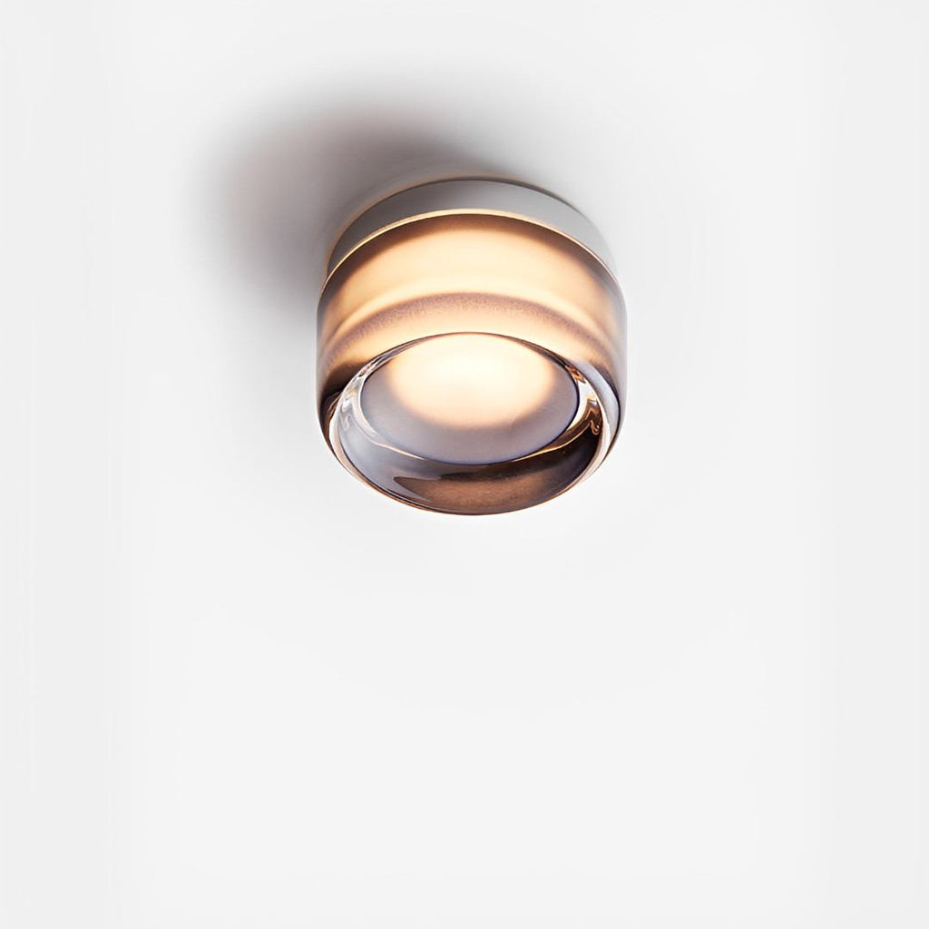 Compact Wall Light - DimpleGlow in amber beside a bed