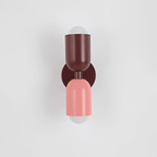 Colourful Up-Down Wall Lamp – Colorwave Double-Sided LED Sconce in pink beside a bed