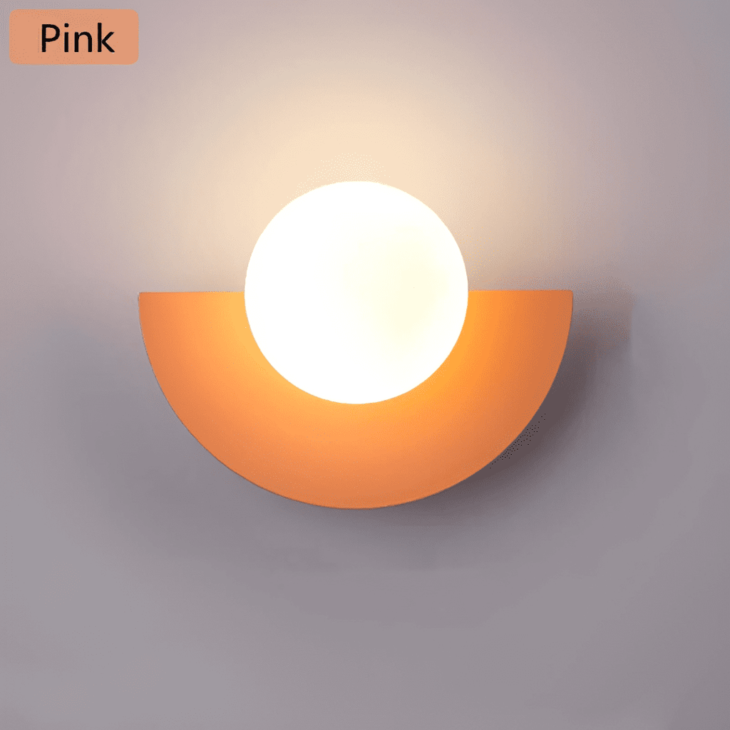 Crescent Moon Wall Lamp – LunaMetal Metal LED Sconce in pink beside a bed