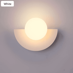 Crescent Moon Wall Lamp – LunaMetal Metal LED Sconce in green in a living room