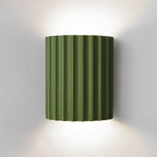 STYLISH RESIN WALL LAMPS - LUMIRESIN in green beside a bed